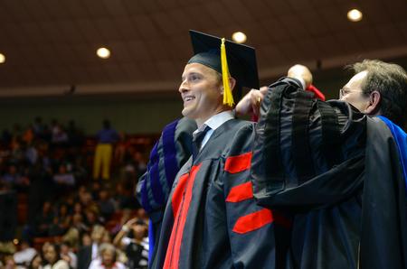 Ben Mandrell, senior pastor of Englewood Baptist Church, Jackson, Tenn., is awarded his doctor of ministry hood during Spring Commencement Services held at the Oman Arena. - Photo by Kathleen Murray