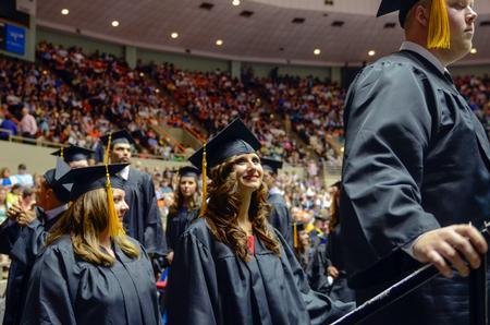 Anna Wolf, center, elementary education graduate, and her classmates prepare to walk across the stage to receive their diplomas during Spring Commencement Services.  - Photo by Kathleen Murray