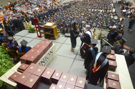 Michelle Lee receives her Bachelor of Science in Business Administration and Mathematics from David S. Dockery, president of the university. - Photo by Amanda Rohde