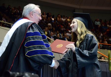 Mckenzie Dorris, mathematics graduate, receives her diploma during the Spring Commencement Services. - Photo by Matt McDaniel