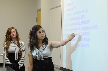 Courtney Valentine, right, junior computer science major, and Megan Bishop, senior computer science major, discuss an Android application created for traffic condition information during their presentation at the annual Scholarship Symposium. - Photo by Jacob Moore