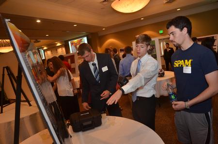 Engineering students Nathaniel Park, Chris Boccarossa, and Adam Long go over their presentation at the Grant Center. - Photo by Morris Abernathy