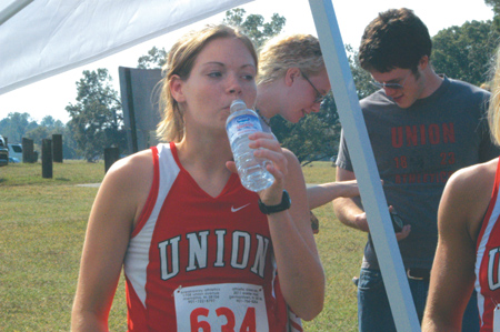 Freshman Jill Konkol stopped to rehydrate during a cross country meet. - Photo by Lindsay Stavish