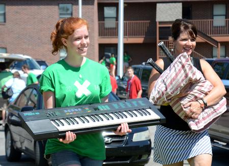 Bethany Malchuk, sophomore music major, and Jan Shultz, administrative assistant, help new students move into their rooms. - Photo by Amanda Rohde
