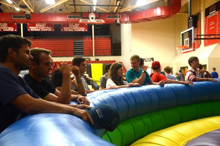 Focus leaders observe an inflatable jousting game during the SAC Focus Fest in the Fred DeLay Gymnasium. - Photo by Meg Rushing