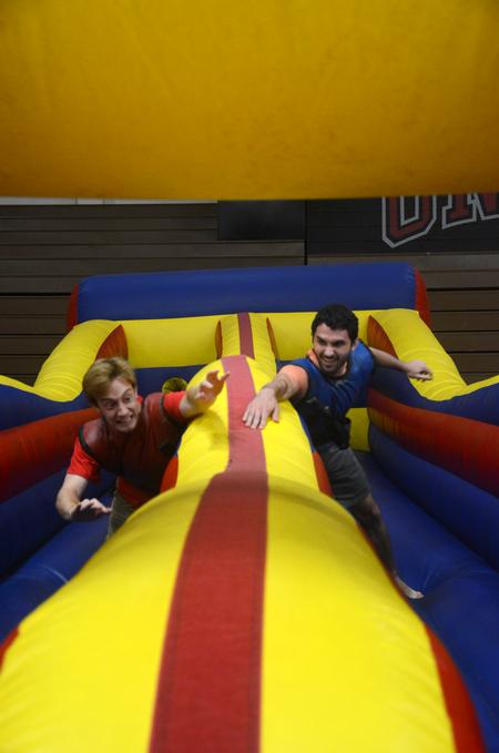 Andrew Stricklin, senior chemistry major, and Cameron Faulk, senior biochemistry major, race on the bungee inflatable at the SAC Focus Fest. - Photo by Meg Rushing