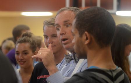 Dr. Dub Oliver, president of the university, talks with new students at the ice cream social in the Bowld Commons. - Photo by Amanda Rohde
