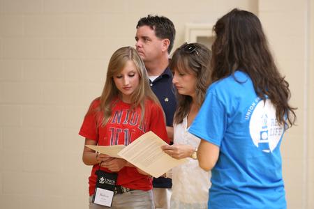 New student Madison Cross and her parents check in on new student move-in day. - Photo by Kristi McMurry Woody