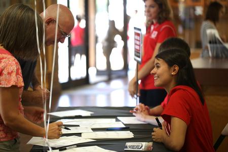 Families of new students make name tags during new student move-in day. - Photo by Kristi McMurry Woody