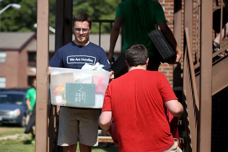Upperclassmen, faculty and staff help new students carry their belongings to their new rooms during move-in day. - Photo by Kristi McMurry Woody