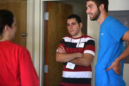 New student Omar Minaya and his family chat with upperclassmen during move-in day. - Photo by Kristi McMurry Woody