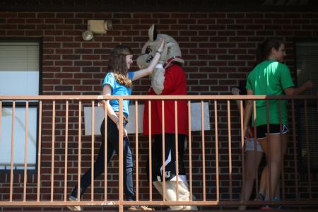 Buster the Bulldog high-fives a new student during move-in day. - Photo by Kristi McMurry Woody