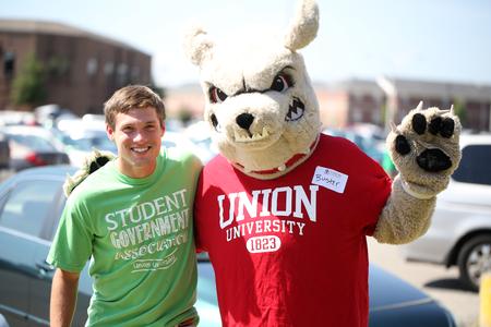 Buster the Bulldog stops to pose with an SGA member during new student move-in day. - Photo by Kristi McMurry Woody