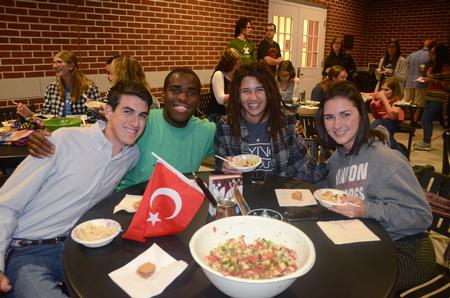 Josiah Murphy, freshman communications major, Tre Tharpe, Christian ministries and missions major, Laura Reiswig, junior philosophy major, and Katie Murchison, junior art major, enjoy a Central Asian dish at a GO Week event on the Bowld Commons patio. - Photo by Meg Rushing