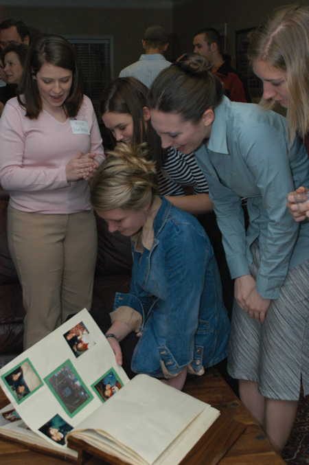 Zeta Tau Alpha members and alumni reminisced over a scrapbook at the All Greek Alumni Reception during Homecoming 2004.  - Photo by Kristen Nicole Sayres