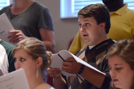 Doug May, senior music education major, rehearses with University Singers in Hartley Hall. - Photo by MiKalla Cotton