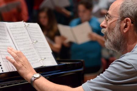 Terry McRoberts, professor of music, accompanies the  University Singers  during rehearsal in Hartley Recital Hall. - Photo by MiKalla Cotton