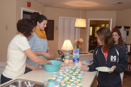 Erin Slater, residence director for Heritage residence complex, and Kayla McKinney, residence director for the female quads, serve students during Res Life's Progressive Snacking event. - Photo by Emily Stookey