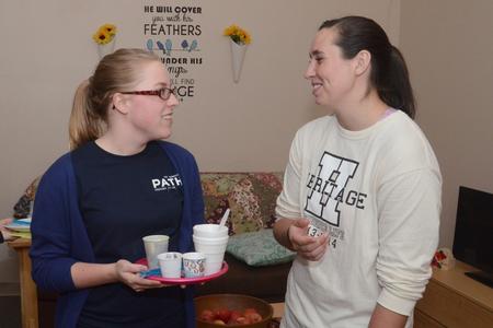 Melody Kramer, senior nursing major, talks with RA Megan Jay, senior nursing major, at Residence Life's Progressive Snacking. - Photo by Emily Stookey