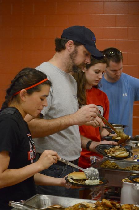 Students and their families come to support Chi Omega's BBQ fundraiser for the Make-A-Wish foundation during Family Weekend.  - Photo by Emily Stookey