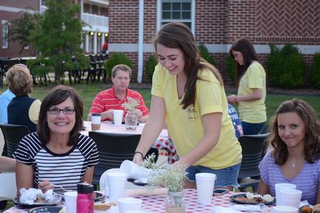 Libbie Atchison, freshman English major, works the Chi Omega Make-A-Wish BBQ fundraiser during Family Weekend. - Photo by Emily Stookey