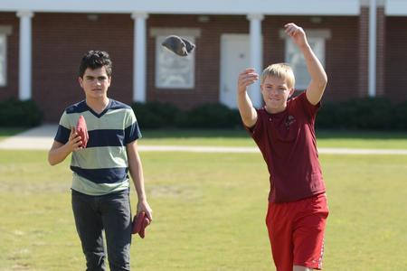 Families of Union students compete in the corn hole tournament during Family Weekend.  - Photo by Emily Stookey