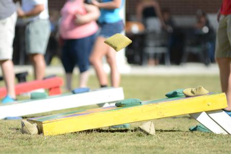 Students and their families compete in the corn hole tournament during Family Weekend. - Photo by Emily Stookey