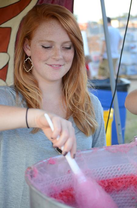 Anna Coley, senior elementary education major, makes cotton candy for families during Union Night, a Family Weekend event. - Photo by Emily Stookey