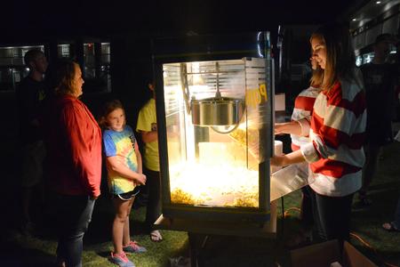 Chelsea Loomis, junior TESL and Spanish double major, gets popcorn with her sisters at Movie on the Lawn, hosted by the Student Activities Council, during Family Weekend. This year's movie was The Lego Movie. - Photo by MiKalla Cotton