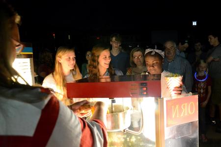 Bailey Coleman, junior business major, Vanessa Taylor, senior nursing major, and Gabby Bonner, senior biology major, wait for their popcorn at the Movie on the Lawn, a SAC event during Family Weekend. - Photo by MiKalla Cotton