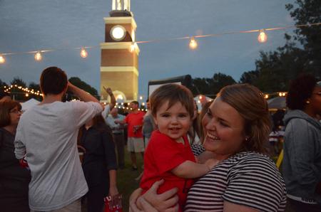 Chelsea Loomis, junior TESL and spanish double major, enjoys time with her little brother at activities on the Great Lawn at Union Night during Family Weekend. - Photo by MiKalla Cotton
