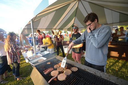 The men of Lambda Chi Alpha cook burgers and hot dogs for guests of Union Night during Family Weekend.  - Photo by Morris Abernathy
