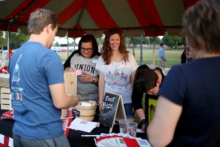 Teresa Rosson, assistant director of development, and the Office of University Relations team gathers entries for door prizes during Union Night.  - Photo by Kristi McMurry Woody