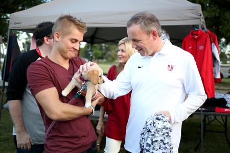 Dub Oliver, president of the university, stops to pet a student's new puppy during Union Night. This event was part of Family Weekend and featured many booths set up by student organizations and departments.  - Photo by Kristi McMurry Woody