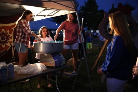 The ladies of Chi Omega mix up cotton candy for guests of Union Night during Family Weekend. - Photo by Kristi McMurry Woody