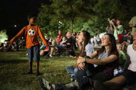 Megan Kersey, senior art major, watches the fireworks display with her family during Union Night, which was the final event of Family Weekend. - Photo by Kristi McMurry Woody