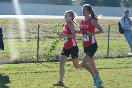 BethAnne Davis, junior nursing major, and Lindsey Jakeman, junior business major, compete together in a cross country meet. - Photo by Meg Rushing