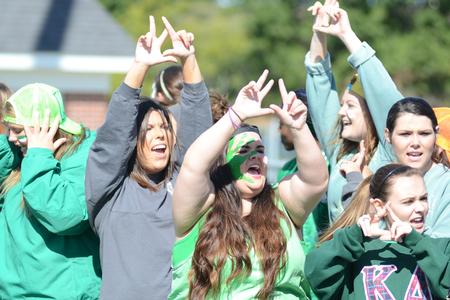 Members of Kappa Delta yell cheers to pump up their sisters before the sprint competition at Greek Olympics. - Photo by Emily Stookey