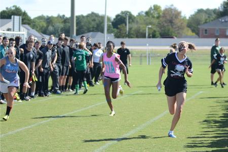 Sorority members race against each other during the sprint relay for Greek Olympics. - Photo by Emily Stookey