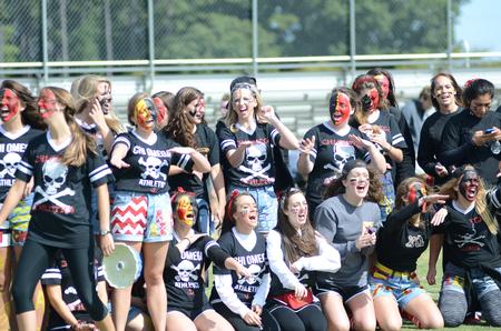 Members of the Chi Omega sorority cheer for their sisters before the start of the chariot pull in Greek Olympics. - Photo by Emily Stookey