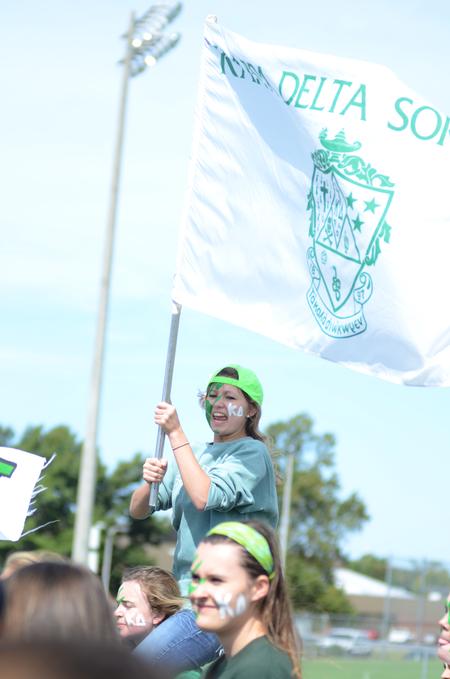 KD Iona McHaney, senior nursing major, proudly carries her sorority's flag during Greek Olympics. - Photo by Emily Stookey