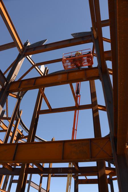 Each day more steel goes up on the Construction site.  Construction workers use very large bolts to connect the steel beams together. - Photo by Morris Abernathy