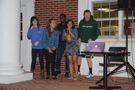 Senior students sing karaoke at Kampfire Karaoke put on by junior council on the front porch of the Bowld Student Commons. - Photo by MiKalla Cotton