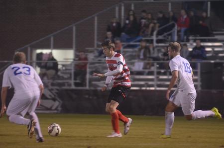 Clayton Martin, junior sport management major, dribbles around opponents from Shorter University. - Photo by Amanda Rohde