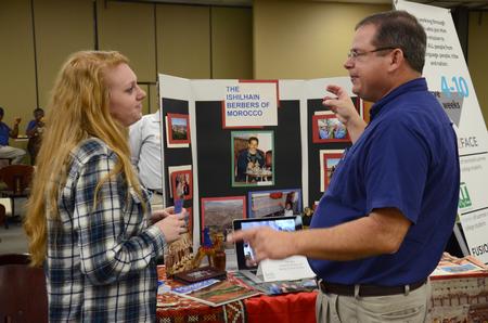 Ashley Carswell, senior Christian studies major, speaks with a representative during the Ministry and Missions Fair hosted by University Ministries in Brewer Dining Hall. - Photo by MiKalla Cotton