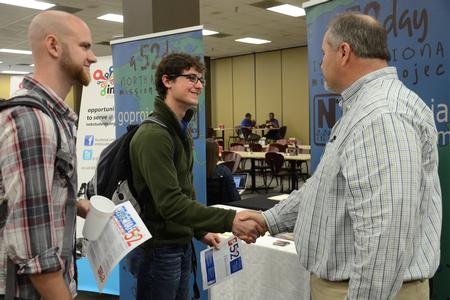 Stephen Ballard,  junior Biblical studies and languages major, and Drake Denning, junior, speak with a North American mission project representative during the Ministry and Missions Fair hosted by University Ministries in Brewer Dining Hall. - Photo by MiKalla Cotton