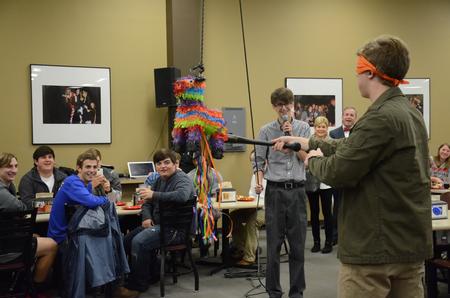 Garyn MacIntyre, sophomore theater major, takes shots at the piñata during a lunch in honor of the upcoming inauguration of Dub Oliver, president of the university, in Brewer Dining Hall. - Photo by MiKalla Cotton