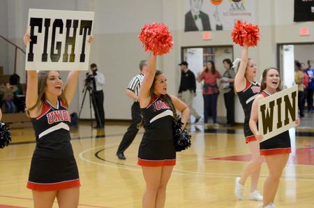 Cheerleaders Sarah Ford, senior psychology major, Deshawn Manley, senior public relations major, and Rachel Carver, junior nursing major, cheer on the lady bulldogs during their game against Robert Morris University.  - Photo by Emily Stookey
