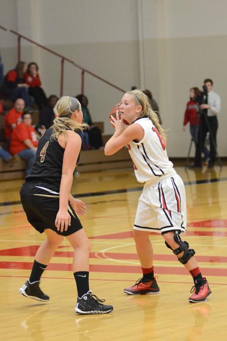 Emily Sissom, senior special education major, looks for an opening to pass the ball during the Homecoming game against Robert Morris University. - Photo by Emily Stookey