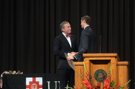 Dub Oliver, president of the university, presents Jon Mark Walls, '07 alumnus, with the Outstanding Young Alumnus Award. - Photo by Amanda Rohde